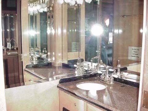 Bathroom vanity with granite countertop and large mirror