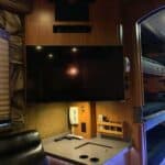Tour bus interior with TV and bunk beds