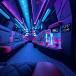 Neon-lit luxury limousine interior with bar and leather seating