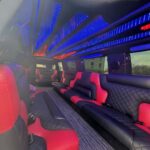 Luxury limousine interior with red-black leather seats and blue LEDs