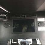 Luxury van interior with TV screen and seats