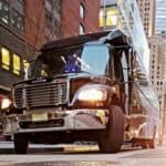 Large delivery truck driving through city street