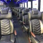 Modern bus interior with black leather seats