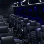Luxury coach bus interior with leather seats and blue lighting