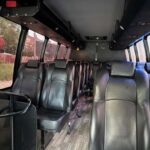 Interior of a shuttle bus with black leather seats