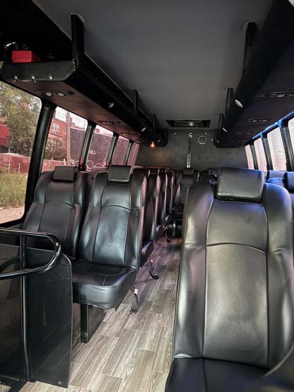 Interior of a shuttle bus with black leather seats