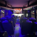 Interior of luxury coach bus with blue lighting and seats