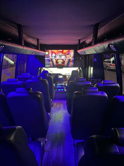 Interior of luxury coach bus with blue lighting and seats