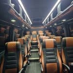 Luxury bus interior with black and brown leather seats