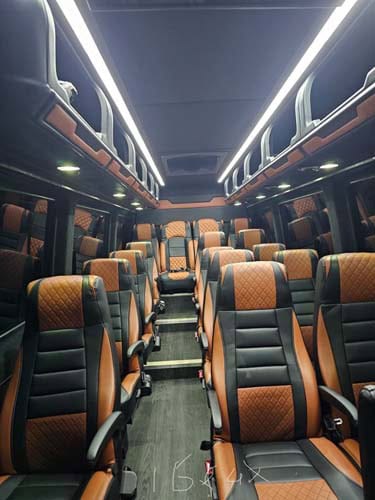 Luxury bus interior with black and brown leather seats