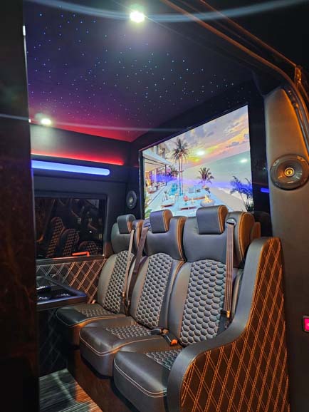 Luxury van interior with leather seats and large screen