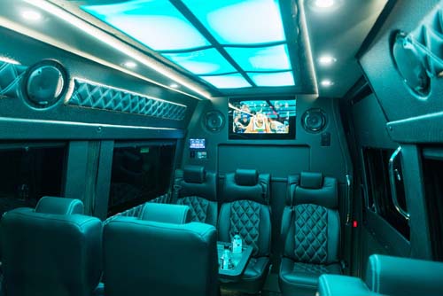Luxury van interior with leather seats and TV