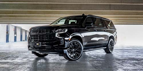 Black full-size SUV in parking garage