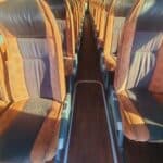 Empty bus interior with aisle and paired seats