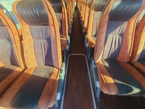 Empty bus interior with aisle and paired seats