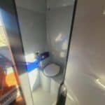 Compact boat bathroom with toilet and shower stall
