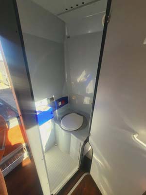 Compact boat bathroom with toilet and shower stall