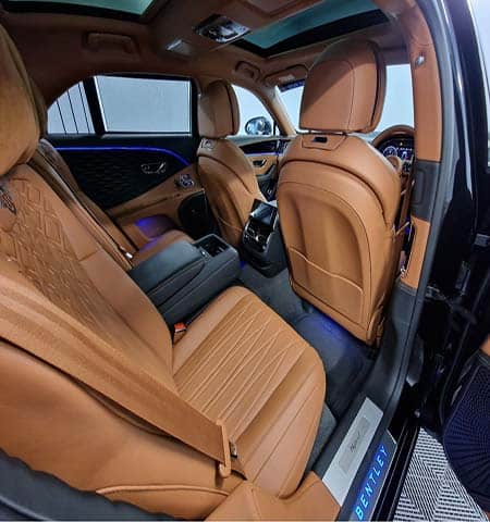 Luxury Bentley rear seat interior with tan leather