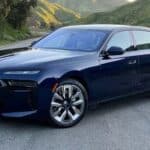 Dark blue BMW luxury sedan on mountain road