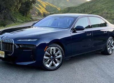 Dark blue BMW luxury sedan on mountain road
