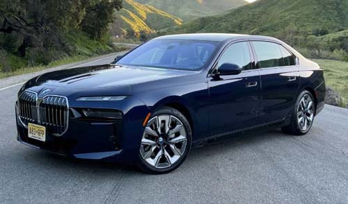 Dark blue BMW luxury sedan on mountain road