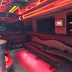 Red neon-lit luxury limousine interior seating area