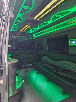 Green neon-lit limousine interior with leather seating