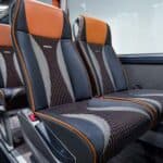 Modern train interior with black and orange seats