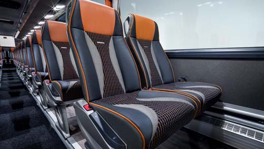 Modern train interior with black and orange seats