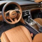 Luxury car interior with tan leather seats and dashboard