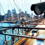 Surveillance camera overlooking city bridge at dusk