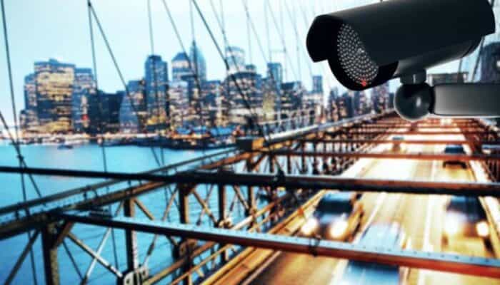 Surveillance camera overlooking city bridge at dusk