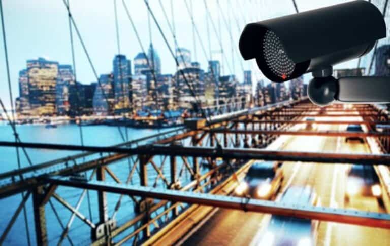 Surveillance camera overlooking city bridge at dusk