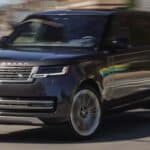 Black Range Rover SUV driving on city street