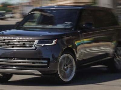Black Range Rover SUV driving on city street