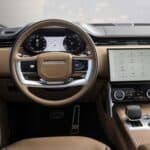 Luxury car interior with touchscreen dashboard and steering wheel