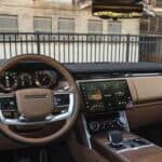 Luxury car interior with steering wheel and dashboard display