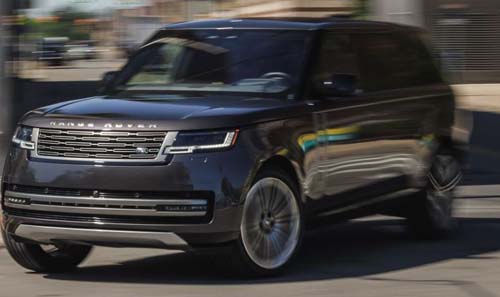 Black Range Rover SUV driving on city street