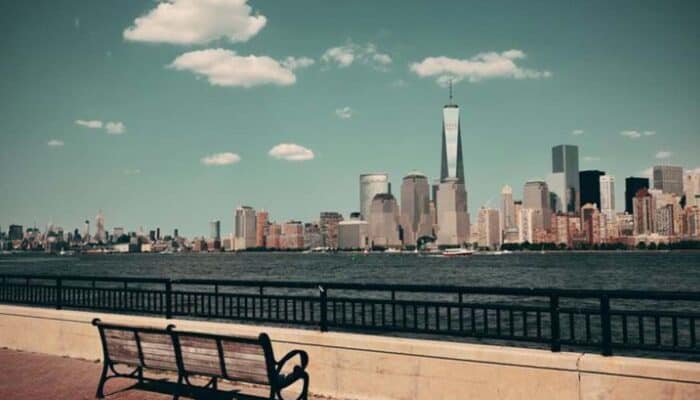 New York City skyline with waterfront bench foreground