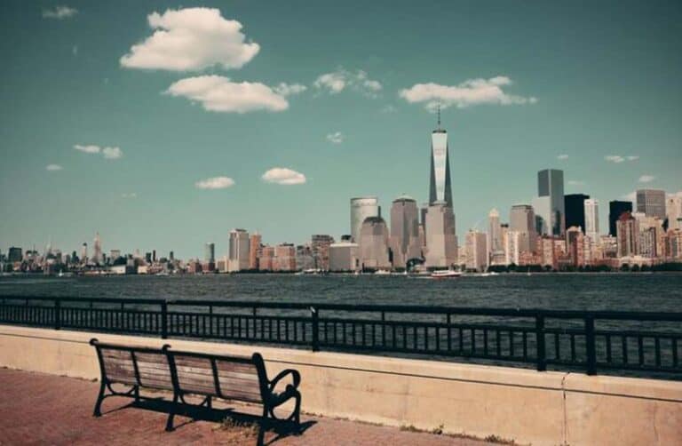 New York City skyline with waterfront bench foreground