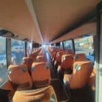 Interior of bus with rows of orange seats