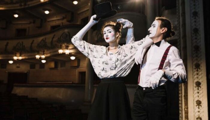 Two mime performers on a theater stage