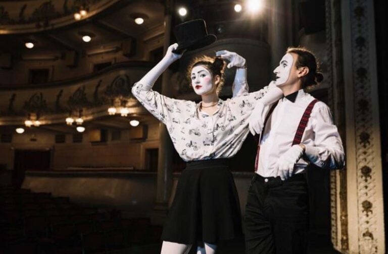 Two mime performers on a theater stage