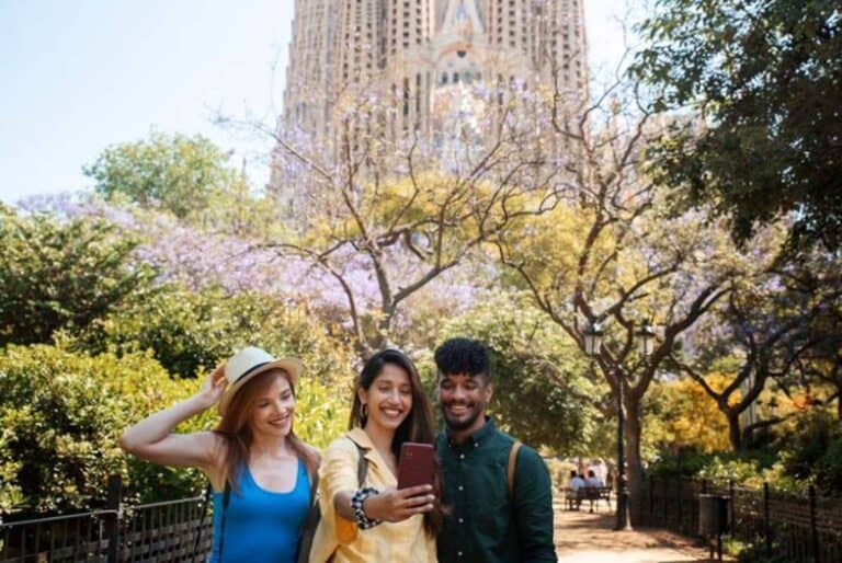 Three friends taking selfie in sunny city park