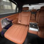 Luxury car rear seats with brown leather and center console