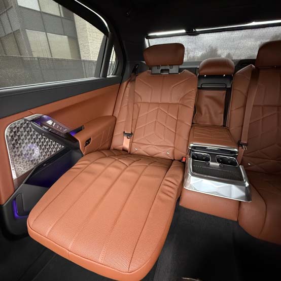 Luxury car rear seats with brown leather and center console