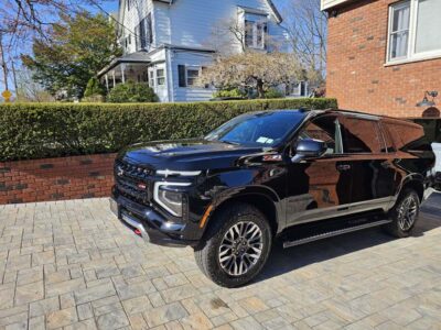 Black Chevrolet SUV parked in residential driveway