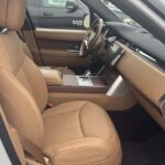Tan leather front seats and dashboard inside luxury SUV