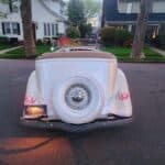 Rear view of vintage white convertible on street