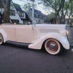 Vintage cream convertible parked on suburban street
